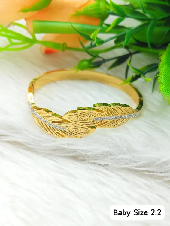 Golden feather bracelet with studded stones